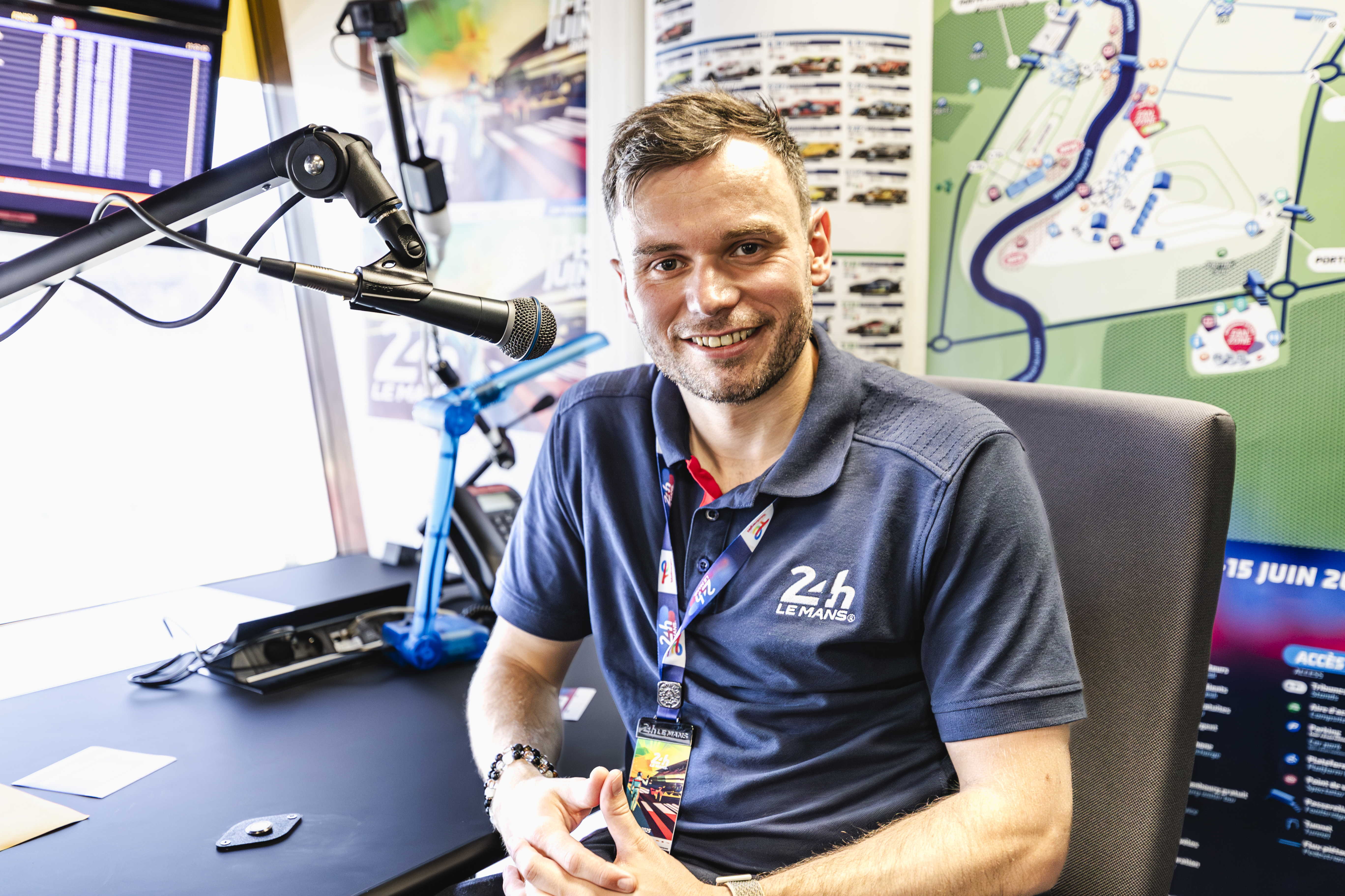 Chris McCarthy at a motor racing commentary position, headset on.